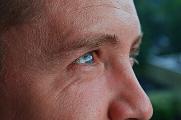 Fototapeta premium Handsome man looking away. eye examination, laser surgery, optical store, advertisement of lenses and glasses, concept of services of ophthalmologic clinic