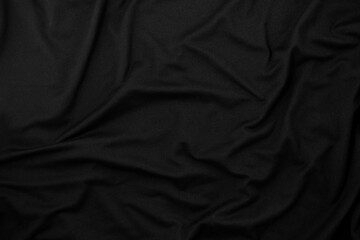 Rippled black fabric texture background. Cloth is wrinkled.