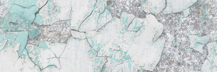Peeling paint on the wall. Old concrete wall with cracked flaking paint. Weathered rough painted surface with patterns of cracks and peeling. High resolution texture for background and design. Closeup