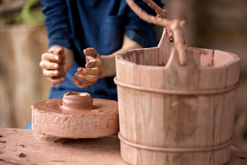 Child making ceramic pot on a farm