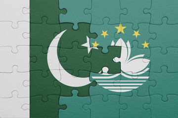 puzzle with the colourful national flag of Macau and flag of pakistan .