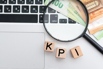 text KPI on wooden cube blocks on white office table.