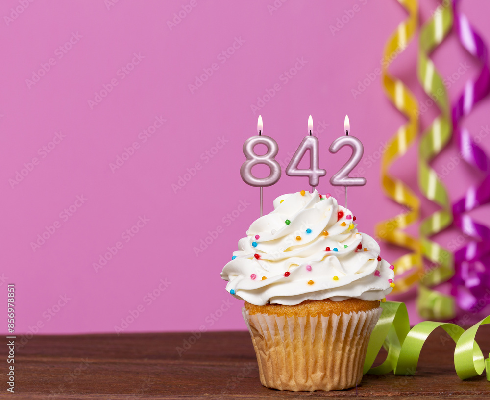 Wall mural birthday cupcake with candles lit forming the number 842