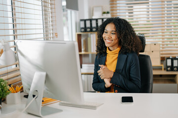 Business woman using tablet and laptop for doing math finance on an office desk, tax