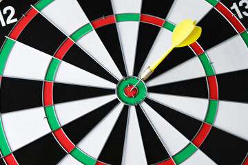 Dart in the center of the dartboard, concept of hitting the target, reaching the goal, determination
