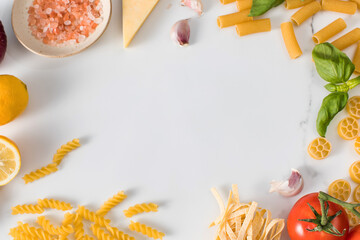 Frame of handmade pasta and cooking ingredients on table