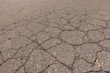 a part of a highway covered with cracked asphalt