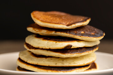 soft fresh pancakes and natural liquid honey in a wooden bowl