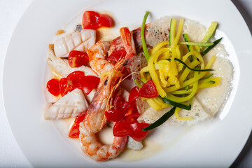 main course cuttlefish and shrimps with julienne courgettes and tomatoes