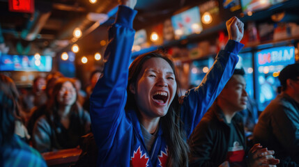 A woman in a sports bar cheers with joy, capturing the excitement and energy of a live sports event.