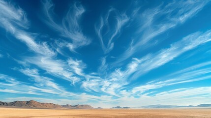 Fototapeta premium Imagine a vast desert landscape beneath an endless expanse of clear blue sky, with wisps of cirrus clouds adding a touch of texture and contrast to the stark beauty of the desert.