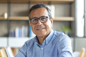 Obraz premium a headshot of a latin entrepreneur wearing glasses at office, CEO at the office portrait