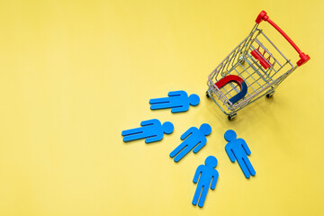 Magnet attract customers towards the shopping cart. Copy space for text. Attract customers and customer acquisition concept.