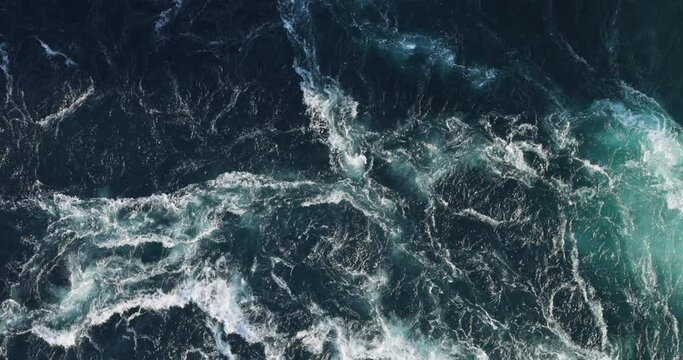 Blue waves of water of the river and the sea meet each other during high tide and low tide.