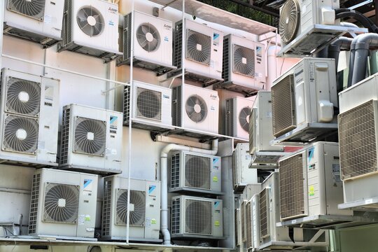 SINGAPORE CITY, SINGAPORE - MARCH 13, 2024: Daikin, Mitsubishi Electric and Panasonic air conditioner units in Singapore.