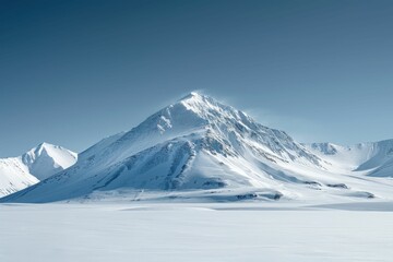 Majestic Snow-Covered Mountain Peak Under Clear Blue Sky in Winter Landscape