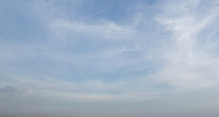 Blue sky background with foggy clouds