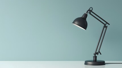 A sophisticated, matte black desk lamp on a clean, white desk, against a soft, pastel blue wall. This photo embodies minimalist office design, with a focus on functionality and aesthetic appeal.