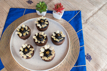 Delicious chocolate cupcake with chocolate and almond frosting . selective focus on subject and...