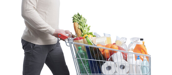 Man doing grocery shopping and pushing a trolley