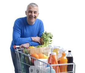 Smiling man posing with a shopping cart