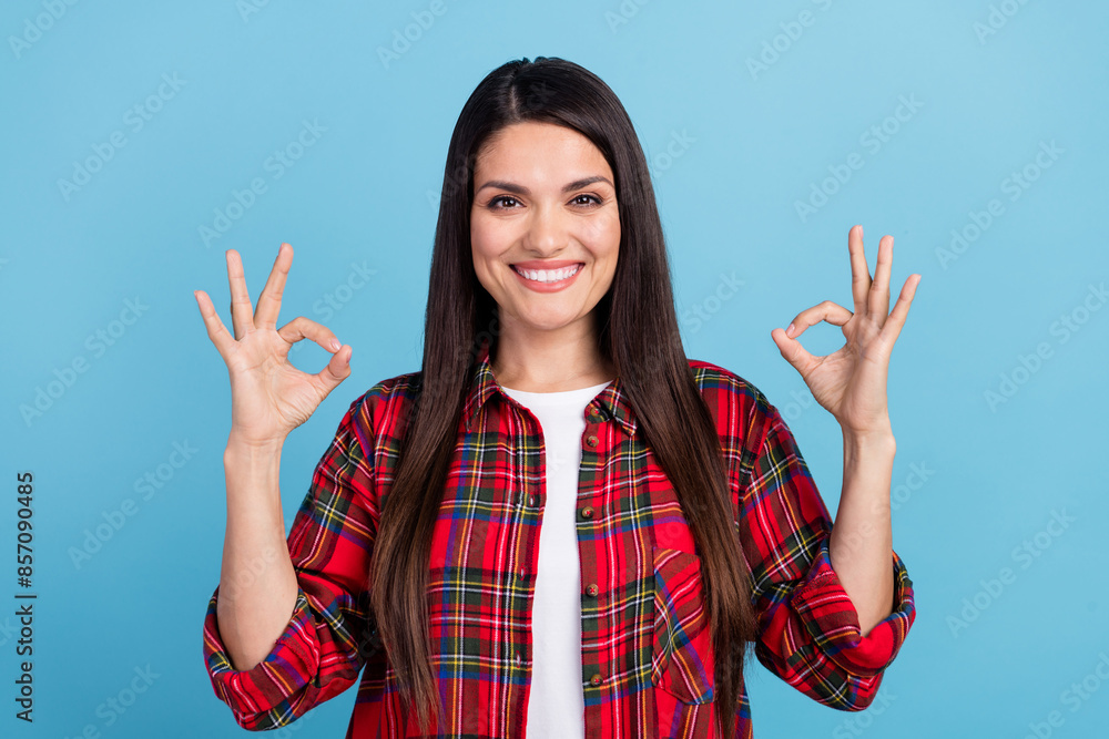 Sticker Portrait photo of attractive brunette hair lady in red checkered shirt showing okey symbol recommendations isolated on blue color background