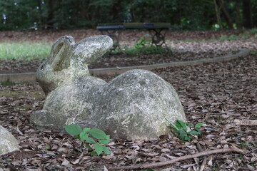 The round buttocks of an old rabbit sculpture in the park