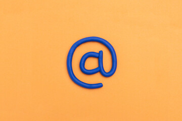 'at' sign. 3d email symbol on orange background. E Mail icon, concept for internet, contact us and e-mail address. 