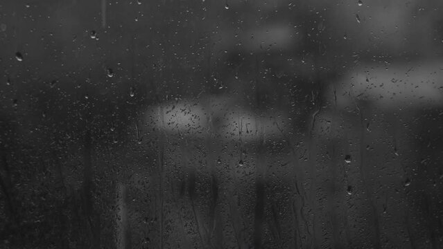 weather background, rain droplets outside the glass window. sad evening light, city urban landscape