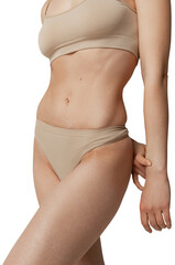 Sportive muscular female body in beige underwear posing against transparent background. Concept of beauty, body and skin care, health, plastic surgery, fashion, cosmetics, spa.