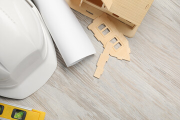 Flat lay composition with building level and other construction tools on white wooden table, space...