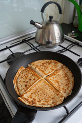 four flour pancakes heated on a griddle