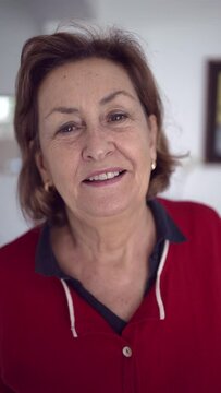 Portrait of Elderly Woman with Green Eyes, Golden Earrings, Red Shirt with Navy Blue Collar, and Blonde Hair - Closeup Of Smiling Lady Zooming In And Zooming Out