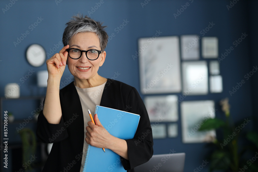 Sticker Smart and successful mature woman working confidently in an office, embodying professionalism and modern corporate culture.