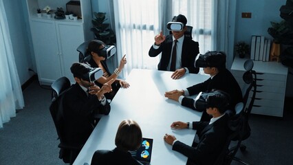 Top view of project manager working on laptop and sending data analysis to business people by using VR glass headset. Professional marketing team enter metadata or virtual world program. Directorate.