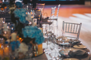 Wedding table settings. banquet table is decorated with plates, cutlery, glasses, candles and flower arrangements. 