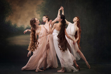 Dance of Muses. Quartet of ballerinas in soft dresses express elegance of classical dance against...