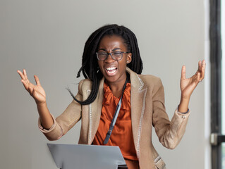 Young African American Businesswoman throwing laptop in frustration