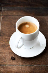 Cup of coffee on wooden background.