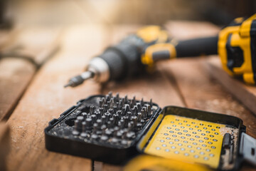 Electric cordless screwdriver. Screwdriver with spare attachments. Iron screw, screws as a...