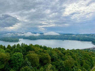 Obraz premium Lake Solina is a largest in Poland water reservoir surrounded by a characteristic landscape of mountains covered with forest and plenty of beaches with tourist infrastructure.