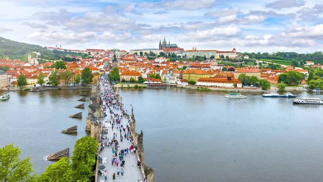 Panoramic time lapse view of the Charles Bridge and old Lesser town with Castle of Prague during a sunny summer day, Czech Republic
