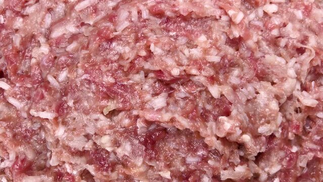 A detailed close-up of a ground meat and rice mixture, commonly used as filling for traditional cabbage rolls. The image highlights the texture and blend of ingredients, essential for the dish. 