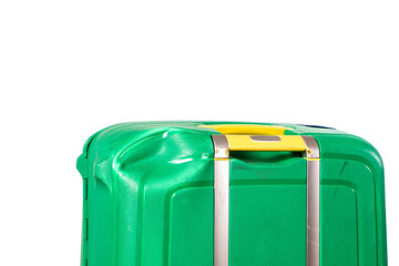 Damaged green suitcase with yellow handles and a big dent on the corner after a transport in an airplane