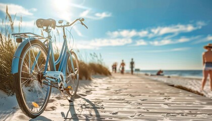 Fototapeta premium A beach cruiser bike parked on a boardwalk with the bright sun shining down and people walking along the sandy beach in the background.