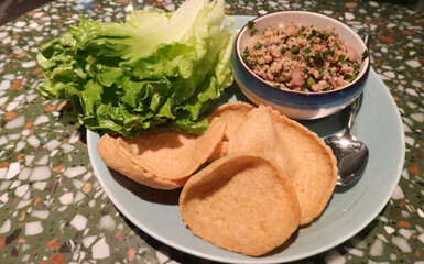 close up of Thai Asian food, Thai Minced Pork with Lettuce Wrap on a blue plate