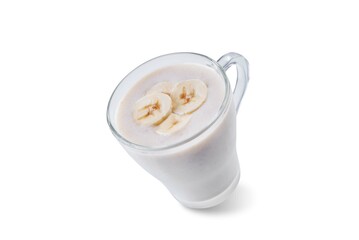Banana milkshake with banana slices in a glass on a white isolated background