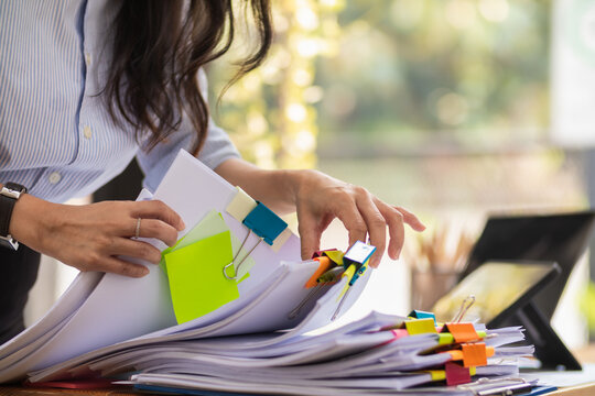 A pile of documents that the secretary has prepared for meetings of the company board of directors and investors. Many documents were arranged and prepared in piles on the desk in the secretary office