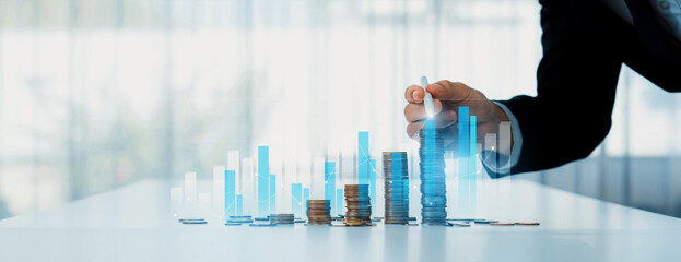 Coin stack with digital graphic indicator symbolizing business investment and economic growth....