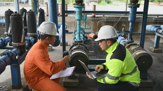 Engineer and technician maintenance checking technical data of system equipment Condenser Water pump and pressure gauge,environmentalist working at water supply
